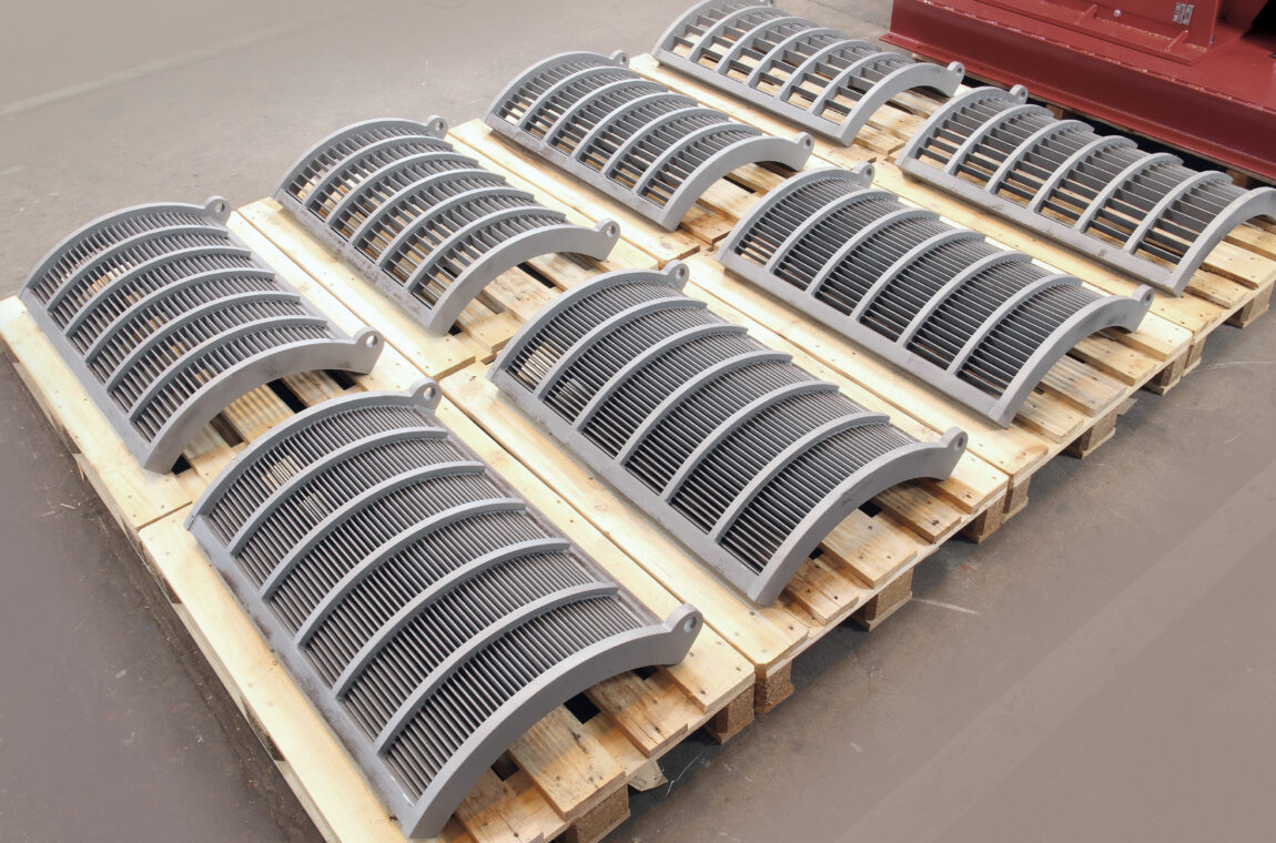 Grate basket halves of the hammer impact mill HM5b on a Euro pallet in our factory hall in Mülheim an der Ruhr
