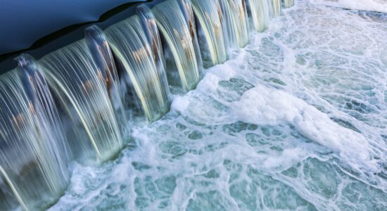 Flowing water, the water flows down a small step from a higher calm pool, below you can see foaming water