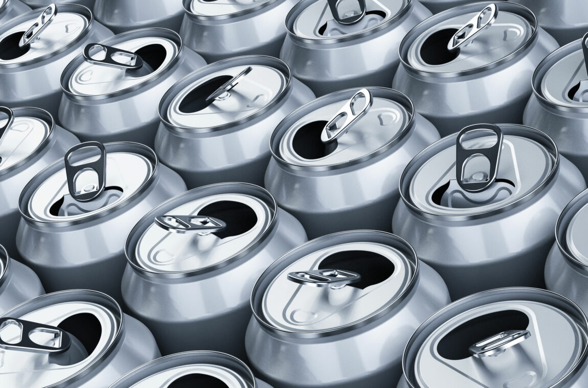 Several already opened aluminum beverage cans standing next to each other