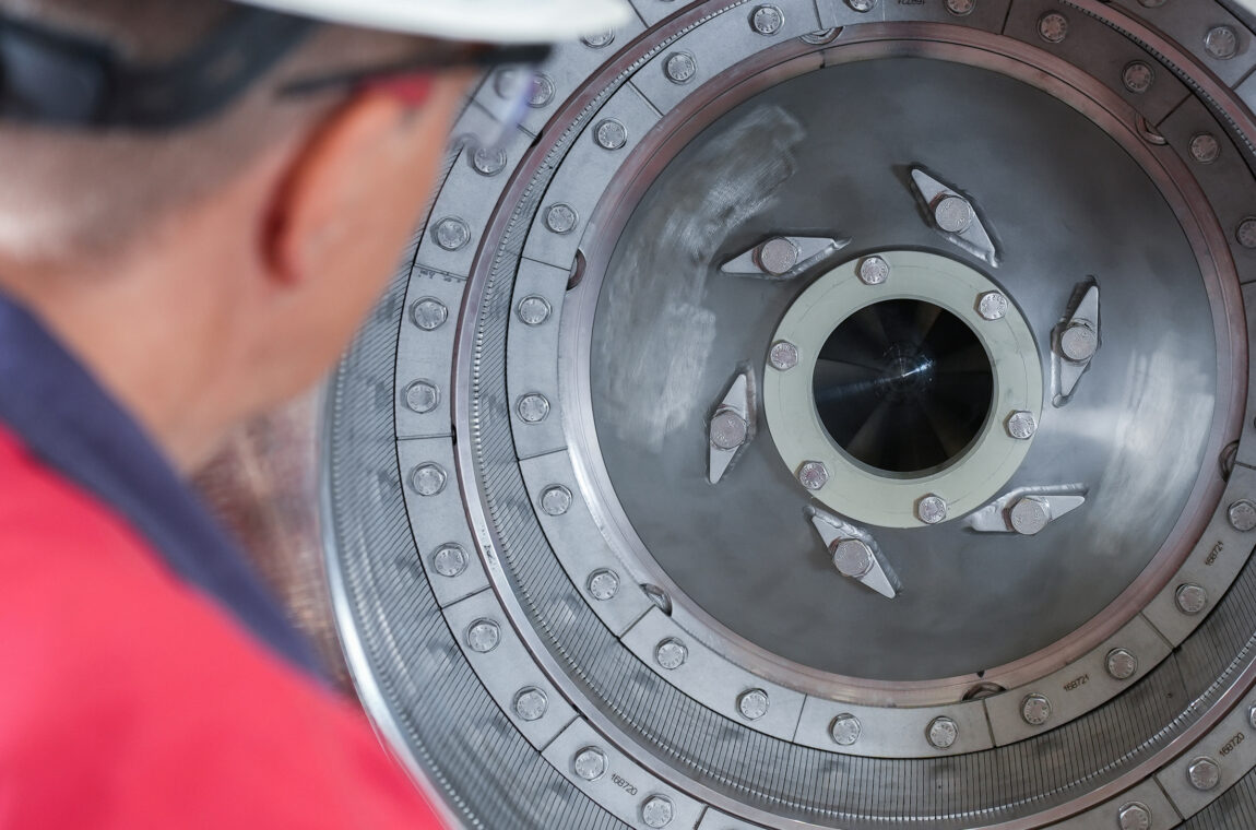 View into the interior of a small pusher centrifuge type SHS. A service technician inspects the slotted screen