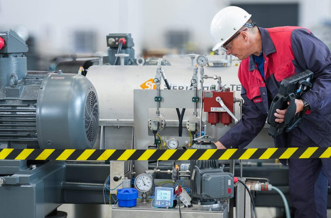 Preventive maintenance. A specialist carries out a machine audit on a decanter