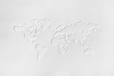 White world map on white textured paper