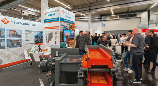 SIEBTECHNIK TEMA exhibition booth at SOLIDS Dortmund 2026, showing the Multiple-Deck-Sizer (MDS) and experts in conversation with visitors.